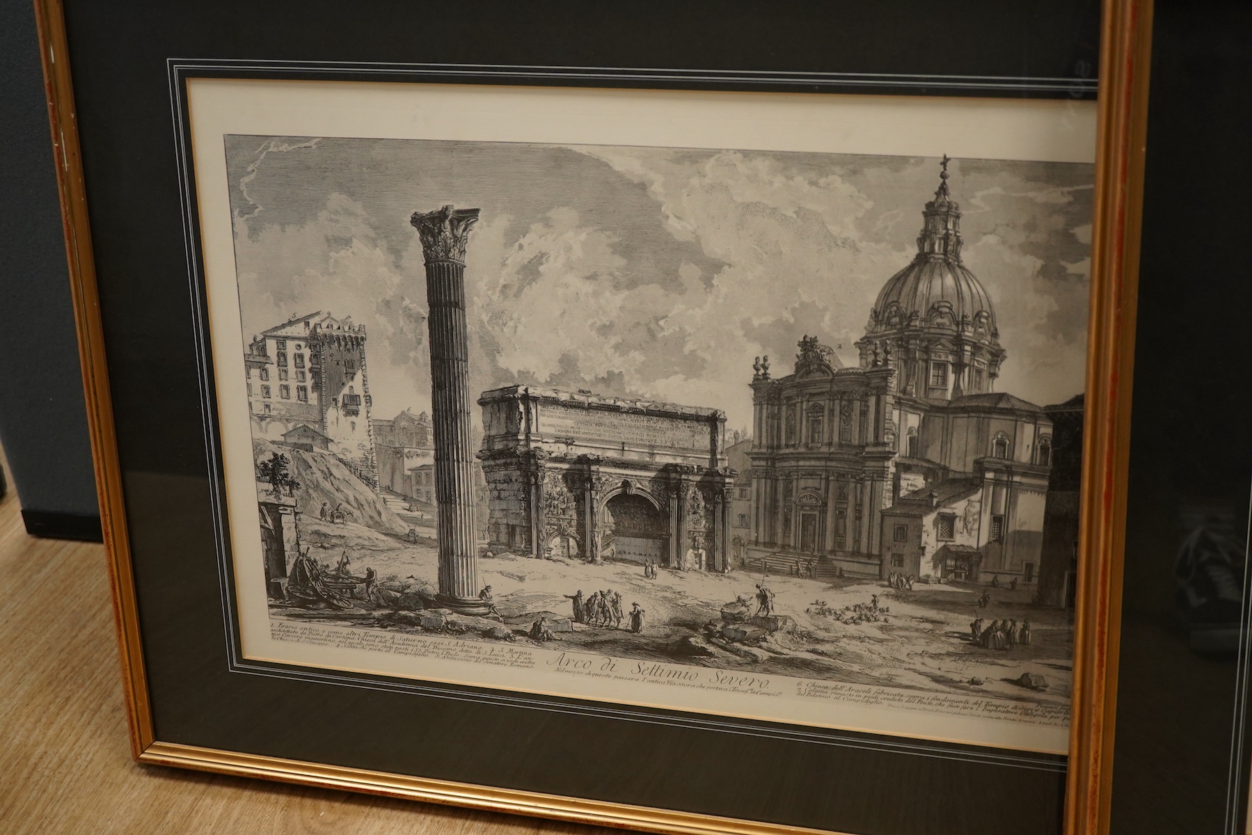 A pair of modern architectural colour prints together with a pair of decorative prints after Piranesi to include: Arco Di Settimio Severo, largest 48 x 73cm, all framed
